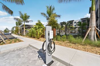 A charging station for electric vehicles is located on a sidewalk.